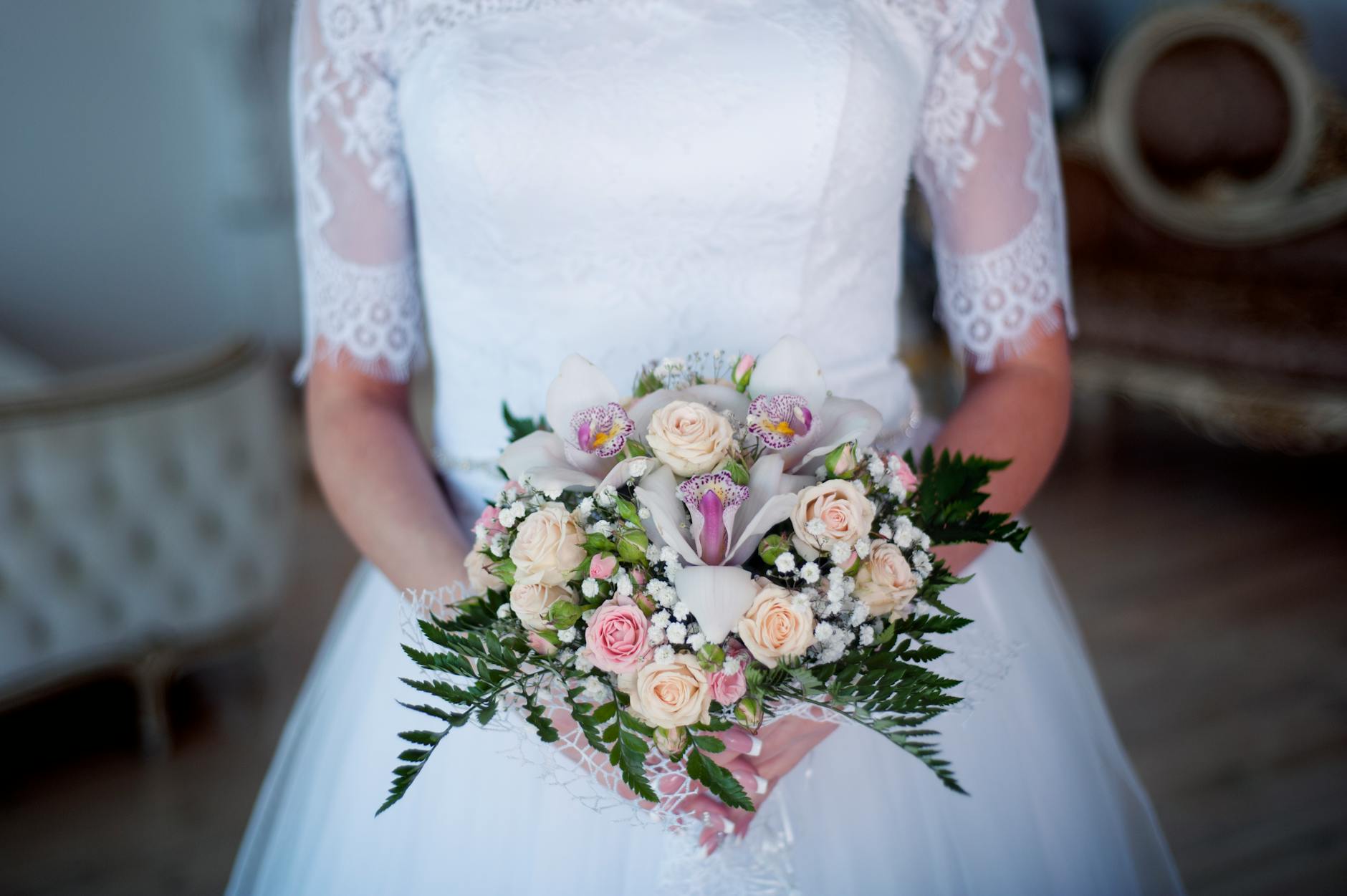 woman wearing wedding gown holding bouquet