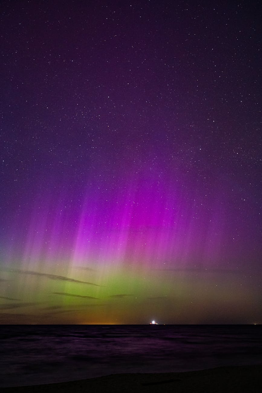 vibrant aurora borealis over stormy sea at night